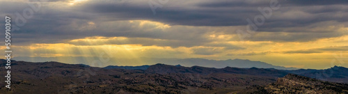 Drone aerial view of a sunset amongst the hills and mountains outside of Cody, Wyoming
