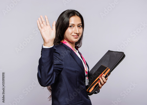 office female colleague send off, isolated on a grey studio back photo
