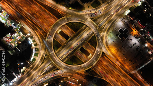 Aerial drone slow shutter night photo of illuminated urban elevated toll ring road junction and interchange overpass passing through Kifisias Avenue, Attica, Greece © aerial-drone