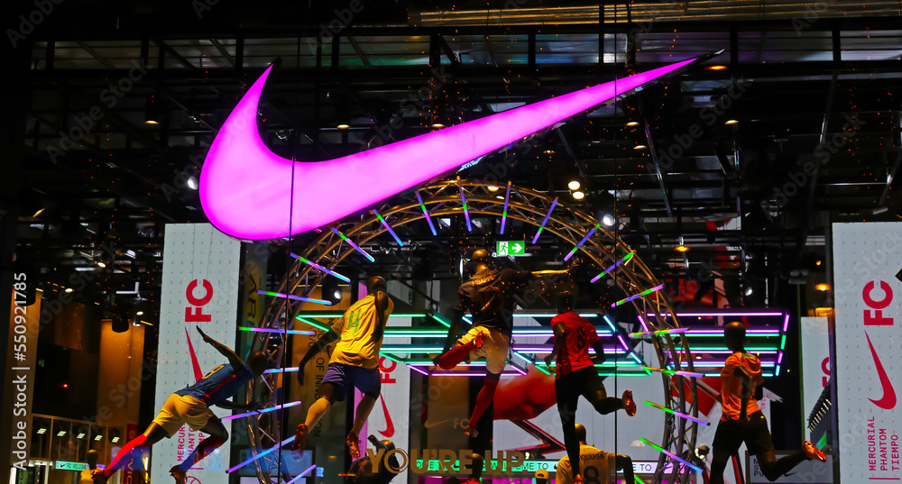 Paris, France - November 29.2022: Closeup of display window of Nike store  at night with neon light logo Stock Photo | Adobe Stock