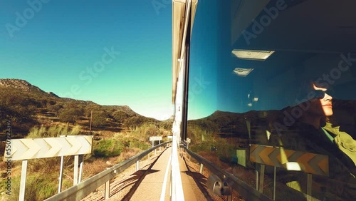 Travel and passenger tourist inside a camper van viewed from outside the window. Alternative home and vanlife lifestyle holiday vacation. Traveler female people inside the vehicle. Driving on the road