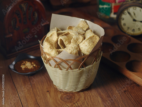 Crunchy Keropok with chili sauce served in basket isolated on table top view of thai food photo