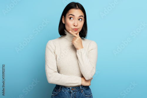 Portrait of thoughtful girl pondering serious issues, looking with uncertain hesitant expression