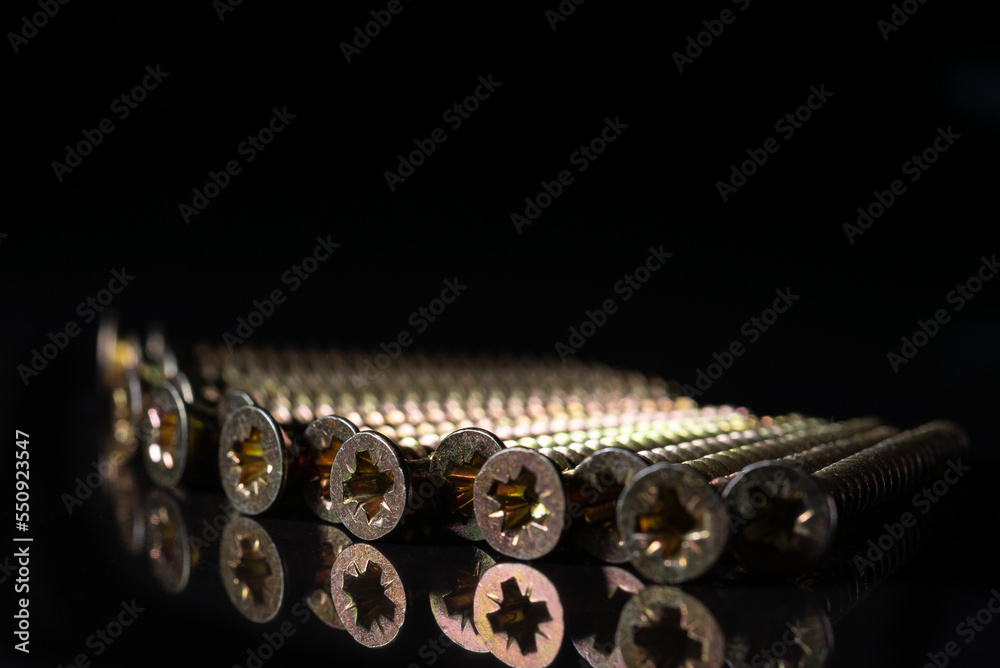 Steel screws for wood. On a black isolated background. Steel screws for wood. On a black isolated background.