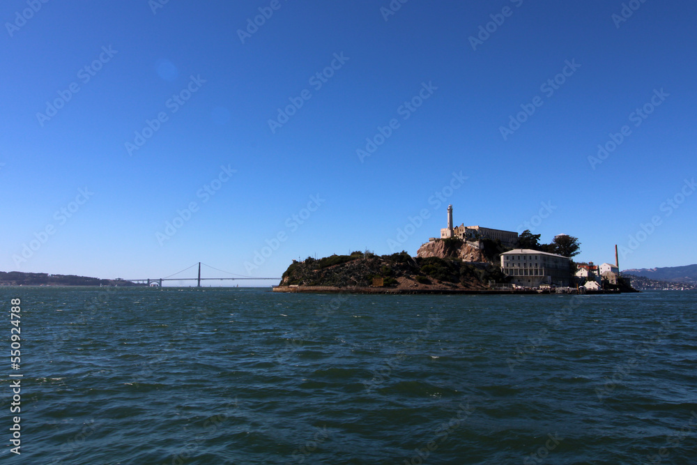 Alcatraz Island and Golden Gate Bridge on sunny day in San Francisco