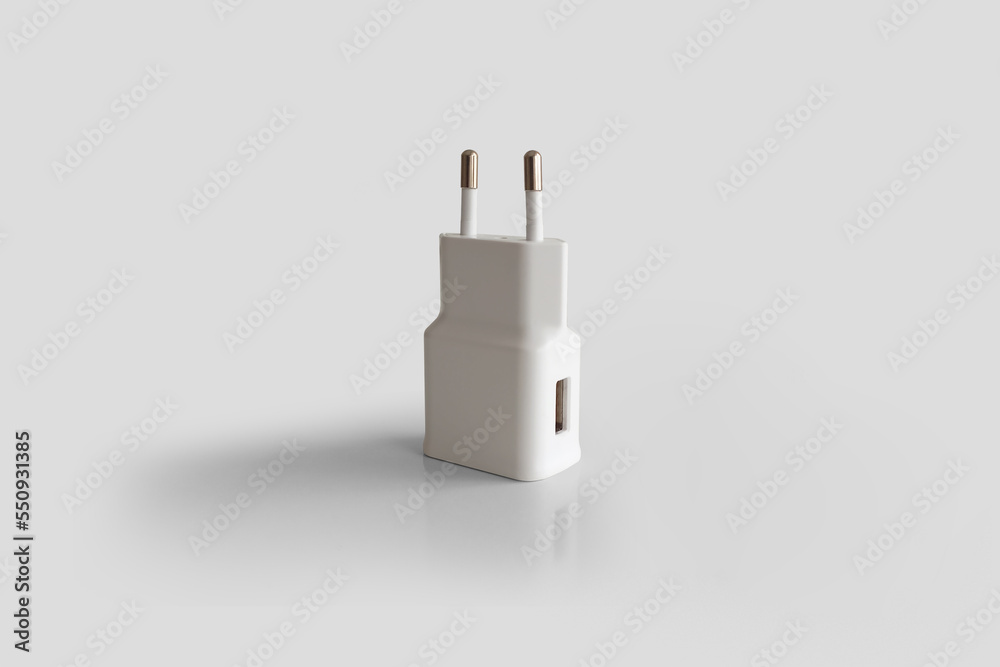 White charger for phones isolated on white background. Battery charger.Full or low energy equipment. White charger for phones isolated on white background. Battery charger.Full or low energy equipment.