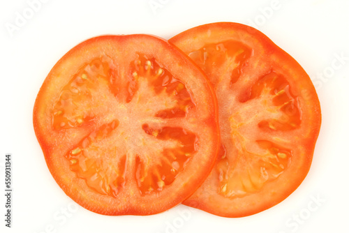 Two slices of tomato isolated on white background