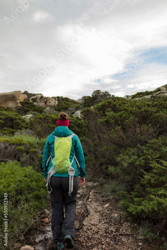 Young woman hiking in the mountains of Sardinia. Wandering in the Mediterranean bush.