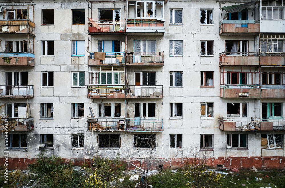 An apartment building in a war zone. Damage to a house as a result of artillery strikes. War in residential areas, broken windows and burned apartments. Armed Conflict in Ukraine