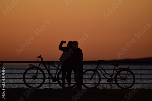 couple taking pictures in the red sunset