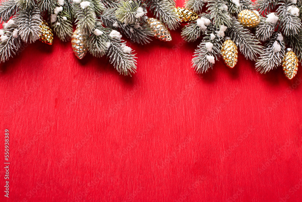 Border from branches of fir tree and decorative golden cones on red ...
