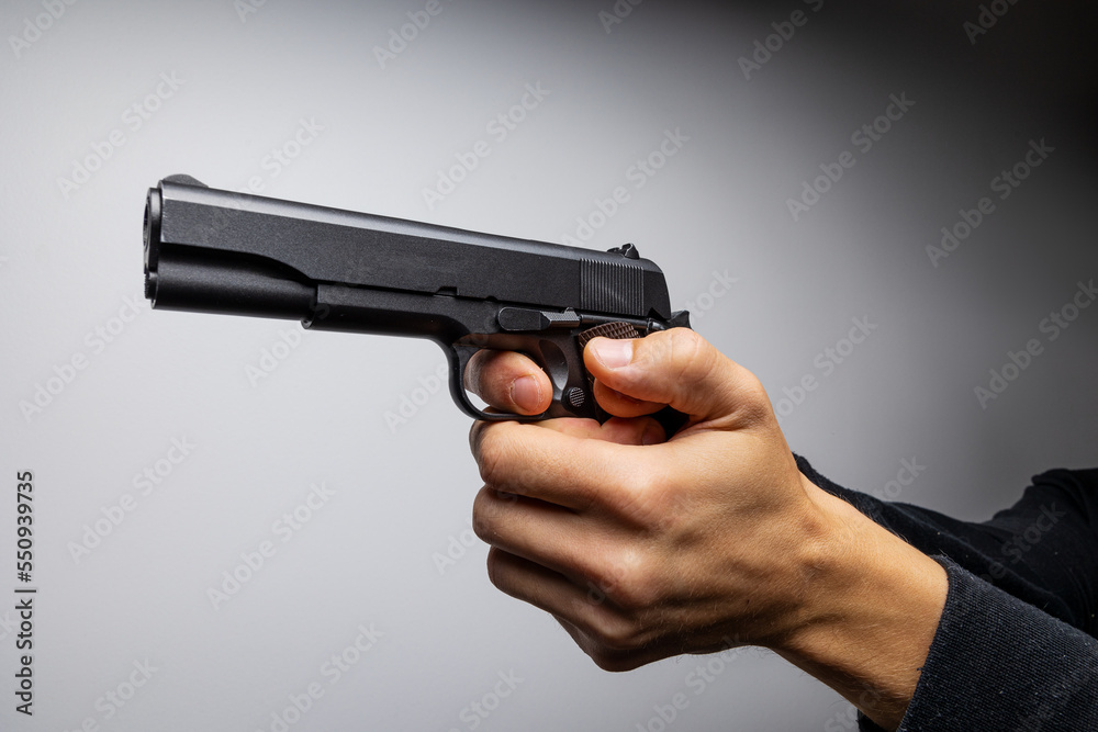 Close up of man hand with aiming gun. Close up of man hand with aiming gun.