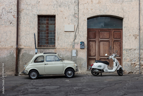 old Italian car and old Italian scooter in front of an ancient house in Italy, traditional scenery, italian Motorroller 