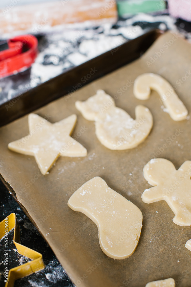 Freshly cut sugar cookies laying out on a cookie sheet ready to bake Freshly cut sugar cookies laying out on a cookie sheet ready to bake