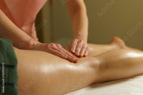 Foot massage. Massage therapist's hands and feet. Massage Studio photo