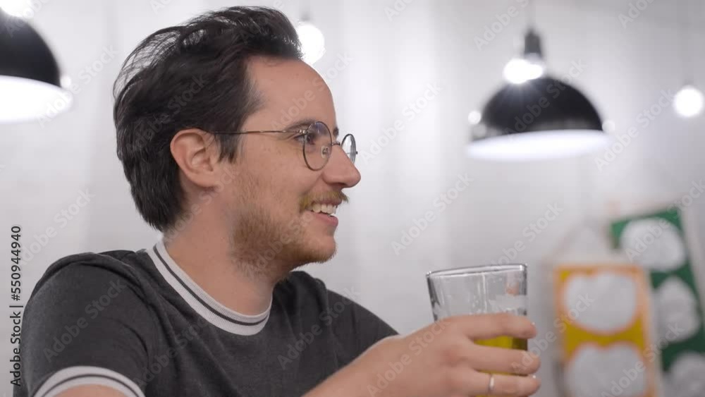 Bisexual man drinks beer at a bar Bisexual man drinks beer at a bar