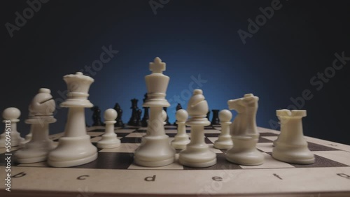 Chess in slowmo falls from the board to the camera. The camera is fixed on a chessboard.