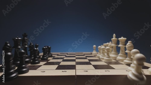 Chess in slowmo falls from the board to the camera. The camera is fixed on a chessboard.