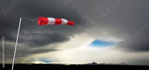 Windbag in huge storm and dark silhouetted mountains. Concept for creative business ideas. Iceland. photo