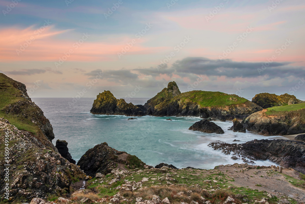Beautiful dawn landscape over Kynance Cove in Cornwall England with vibrant sky and beautiful turquoise ocean