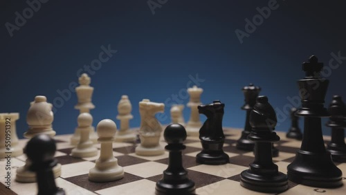 Chess in slowmo falls from the board to the camera. The camera is fixed on a chessboard.