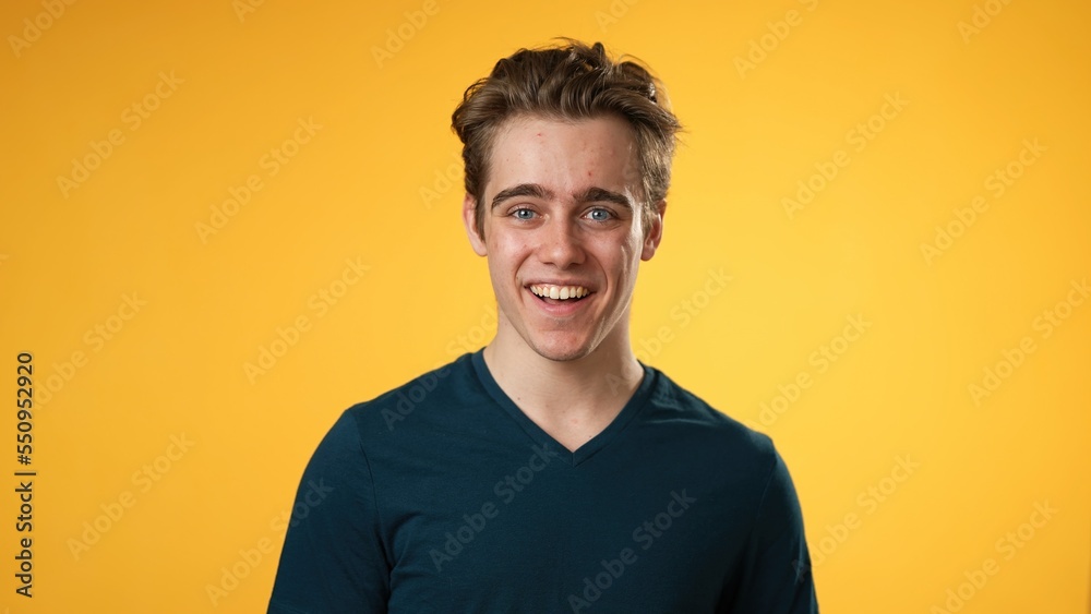 Portrait of smiling happy young hipster man 20s isolated on solid yellow background with copy space in studio Portrait of smiling happy young hipster man 20s isolated on solid yellow background with copy space in studio