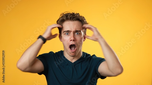 Handsome thinking young man 20s, looks at camera gives mind blown gesture showing explosion of ideas posing on green screen background.