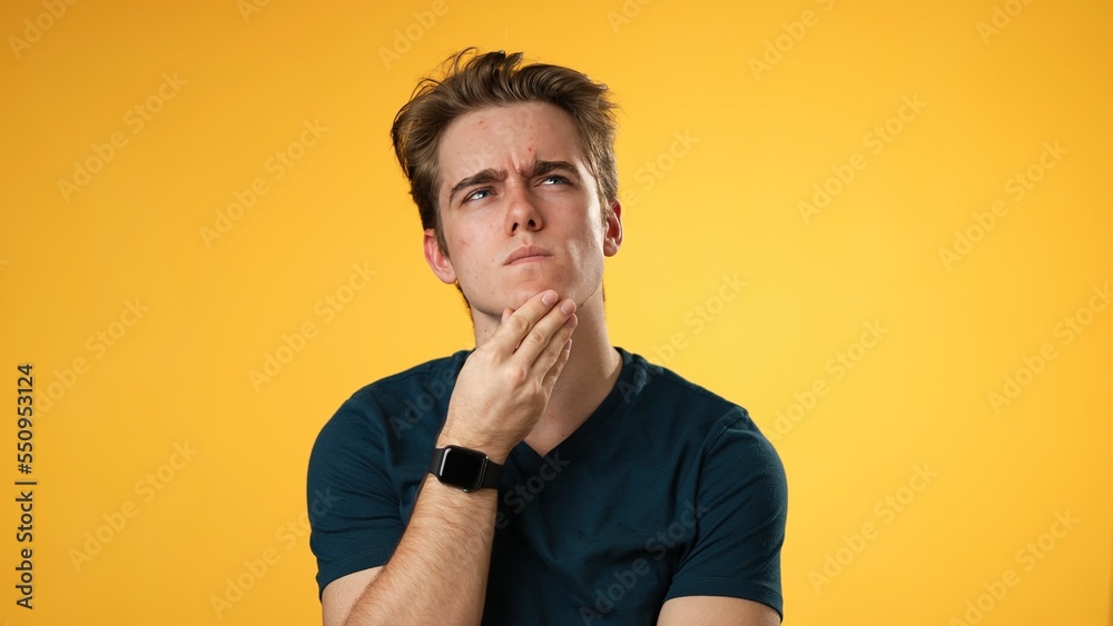 Portrait of thinking, smart puzzled pensive young hipster man 20s looks around thinks comes up with ideas raised finger isolated on yellow background studio portrait Portrait of thinking, smart puzzled pensive young hipster man 20s looks around thinks comes up with ideas raised finger isolated on yellow background studio portrait