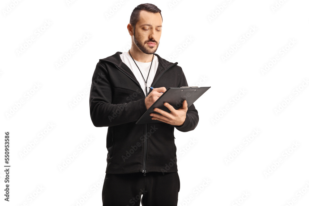 Sports coach with a whistle writing a strategy Sports coach with a whistle writing a strategy