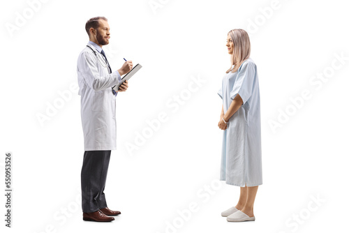 Male doctor writing a document and talking to a hospitalized female patient