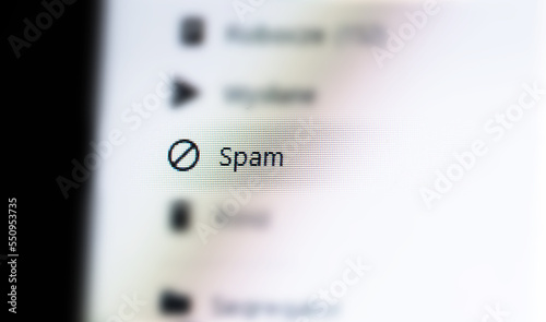 Spam messages folder in a generic email client web app, unwanted mail ads spam e-mail AI filtering, message filters, phishing mitigation abstract concept, nobody. Desktop PC, computer monitor, screen