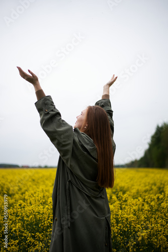 Cheerful girl in the field in summer