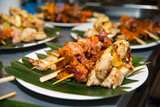 Caribbean-style kebabs of shrimp, sweet yams, bacon, and chicken fillet with pineapple on the leaves