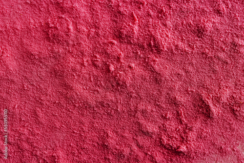 Powder surface close-up, magenta color abstract background photo