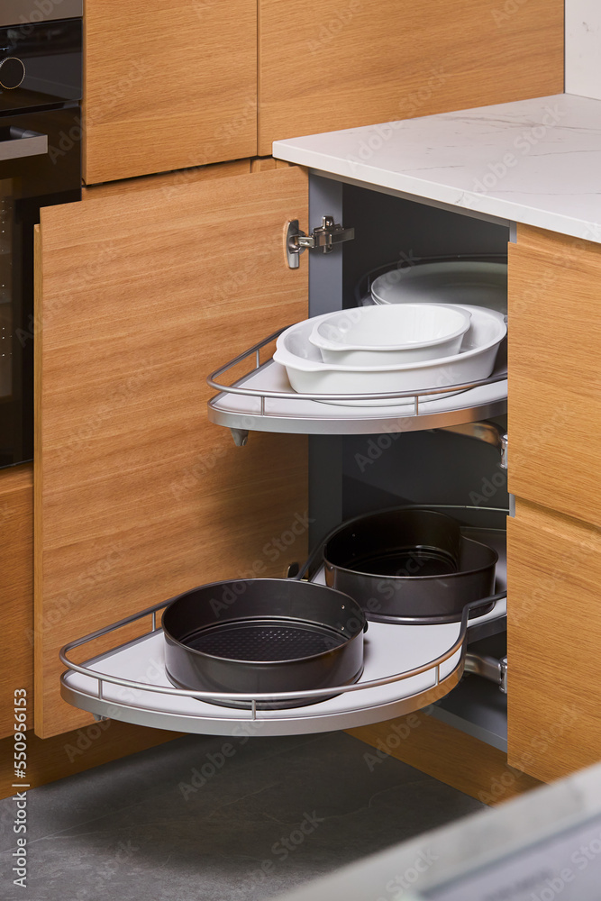 Kitchen access mechanism Magic corner for Blind Corner Cabinets. Solution  for a kitchen corner storage in cupboard. Corner unit with pull out shelves  for cookware ajar. Stock-Foto | Adobe Stock