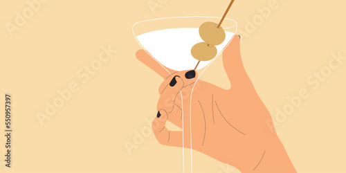 Female hand holding a martini glass with olives.	