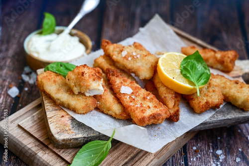   Allasca Pollock Fish  Bites in a crispy Tempura  Batter.Fish and chips .Close up of   crispy breaded  deep fried fish fingers with breadcrumbs s erved with remoulade sauce and  lemon