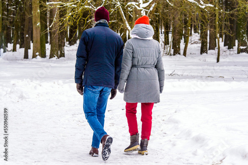 A guy and a girl walking in winter Park