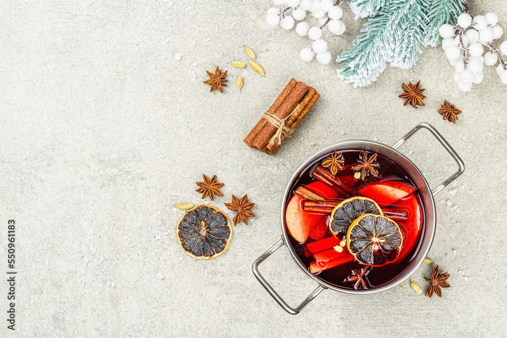 Mulled wine with spices in a pot with traditional Christmas decor. Hot beverage, festive background Mulled wine with spices in a pot with traditional Christmas decor. Hot beverage, festive background