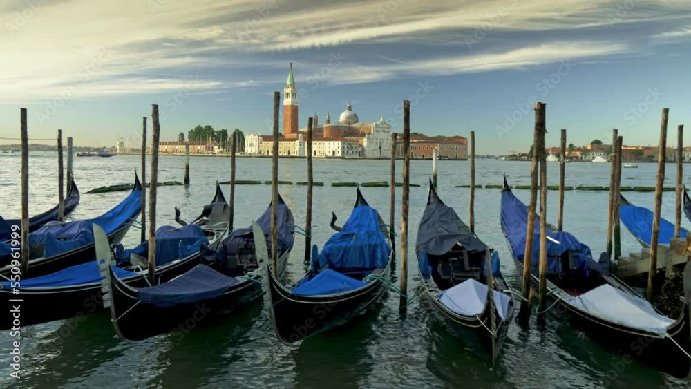 Gimbal shot of gondolas at San Giorgio Maggiore in Venice. Swinging boat on the shore in Venice, Italy Gimbal shot of gondolas at San Giorgio Maggiore in Venice. Swinging boat on the shore in Venice, Italy