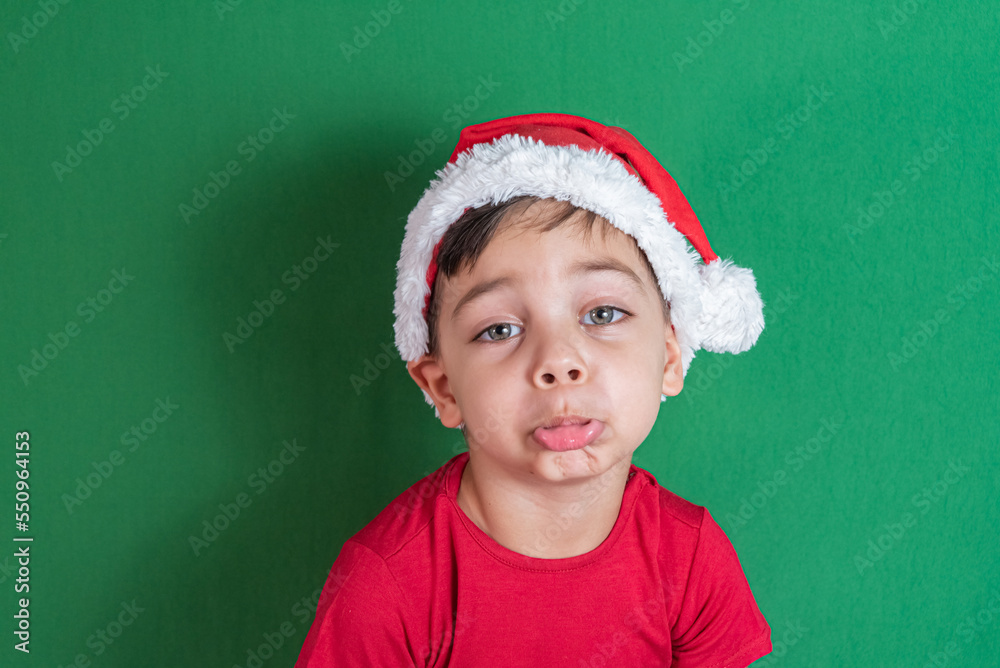 Happy and smiling boy with christmas hat Happy and smiling boy with christmas hat
