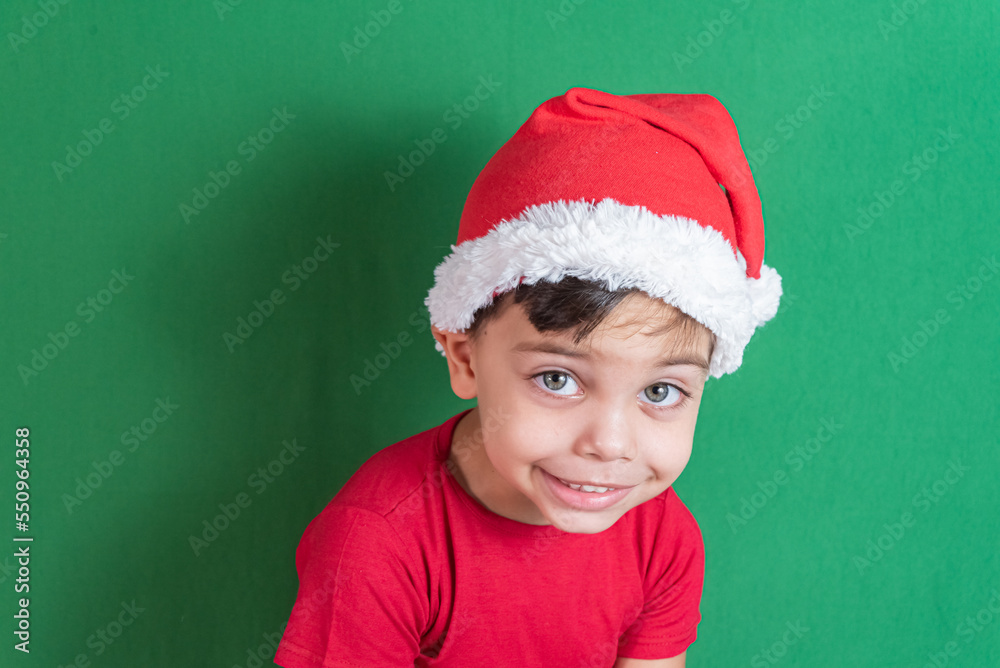 Happy and smiling boy with christmas hat Happy and smiling boy with christmas hat