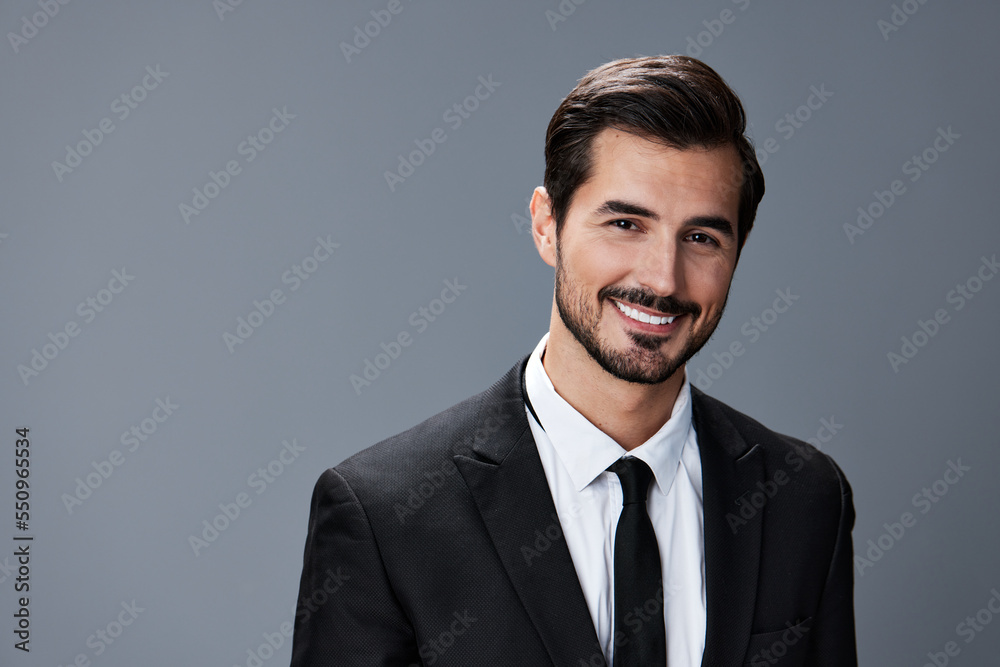 Portrait of a business man with a natural smile with teeth on a gray background in a business suit. Business portrait of a stylish man copy space Portrait of a business man with a natural smile with teeth on a gray background in a business suit. Business portrait of a stylish man copy space
