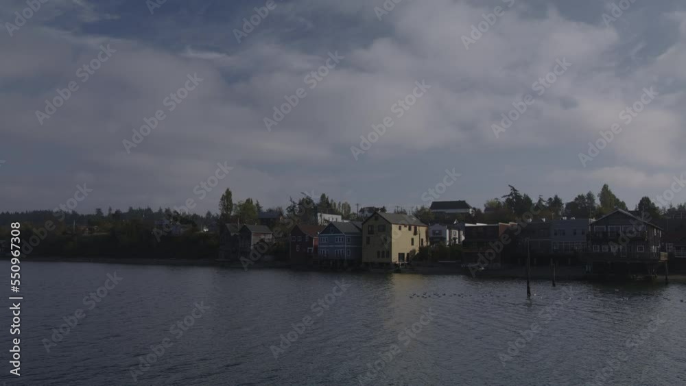 Clouds over houses at waterfront / Coupeville, Washington, United States Clouds over houses at waterfront / Coupeville, Washington, United States