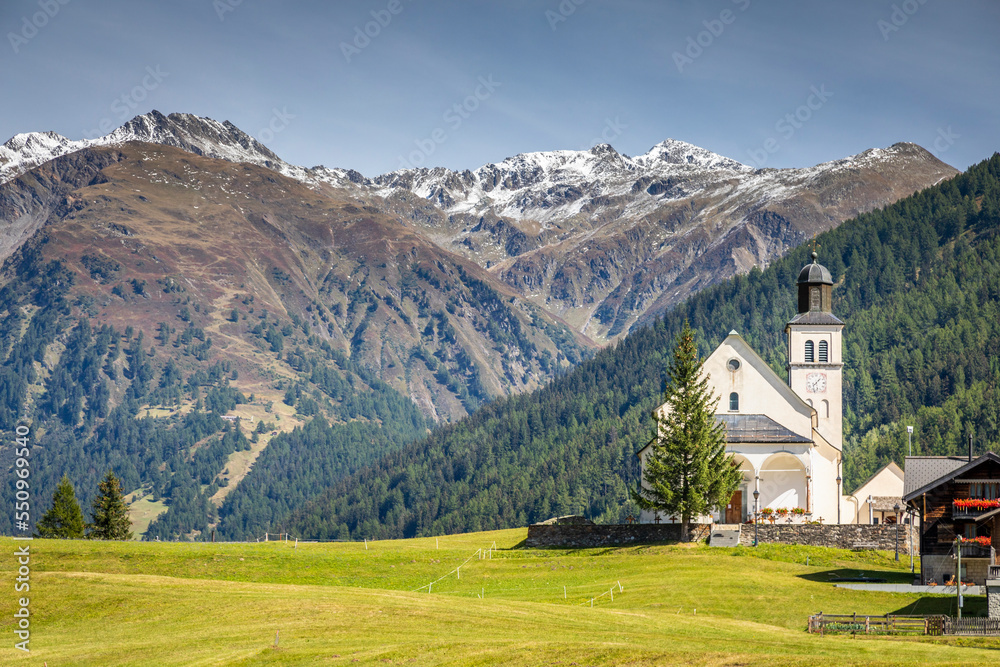 Idyllic landscape of church in Engadine valley, Swiss Alps, Switzerland