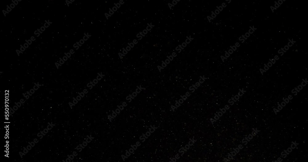 Cinematic dust particles floating on black background in slow motion. Atmosphere overlay. Filmed with RED camera. High quality 4k footage Cinematic dust particles floating on black background in slow motion. Atmosphere overlay. Filmed with RED camera. High quality 4k footage