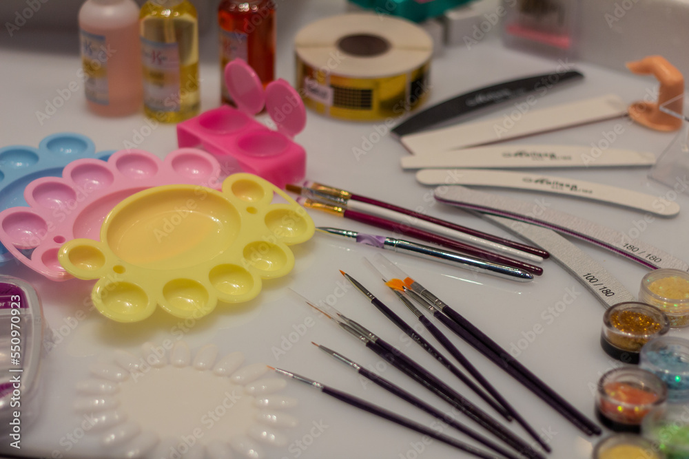 Make-up products, brushes, trays in blue, pink, yellow. Make-up products, brushes, trays in blue, pink, yellow.