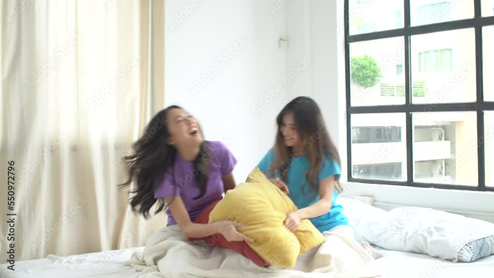 Happy asian lesbian couple using pillow playful hitting together on bed spending time. Cheerful lgbt girl battle use pillow activity laughing leisure relax together at apartment. Lifestyle Lgbtq lover Happy asian lesbian couple using pillow playful hitting together on bed spending time. Cheerful lgbt girl battle use pillow activity laughing leisure relax together at apartment. Lifestyle Lgbtq lover