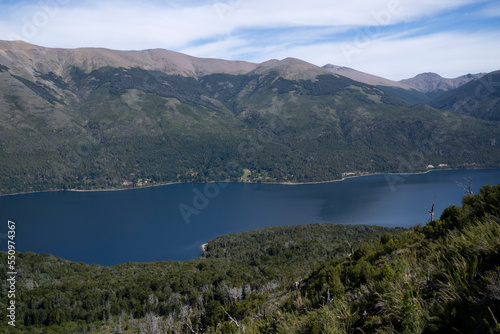 View of the forest, blue water Gutierrez lake and Catedral hill in Bariloche, Patagonia Argentina.