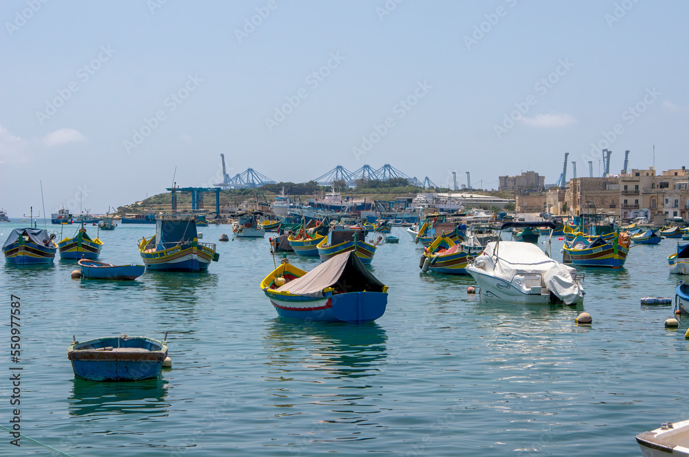 Traditional luzzu boats on harbour, Marsaxlokk, Malta